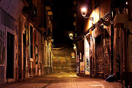 photo of brown concrete pathway between buildings thumbnail