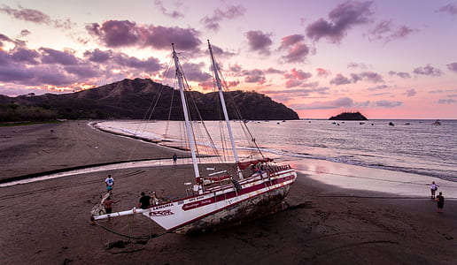 white boat on seashore thumbnail