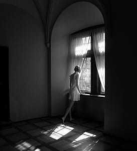 woman wearing white dress beside window and curtain thumbnail