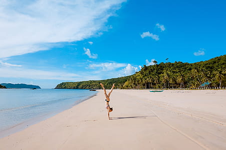 woman doing handstand on beach thumbnail