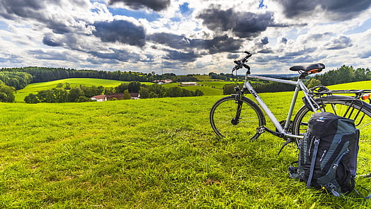 white hardtail bike on green grass under white clouds at daytime thumbnail