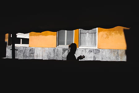 silhouette photo of person near house thumbnail