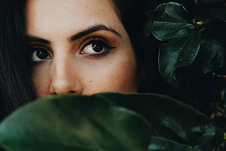 selective focus photography of woman hiding in leaves thumbnail