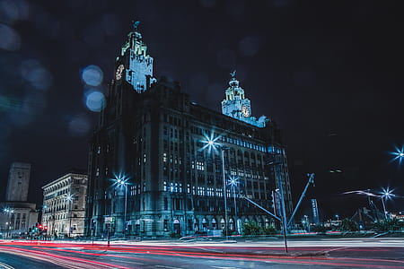 timelapse photography of vehicle lights passing on road in front of cathedral thumbnail