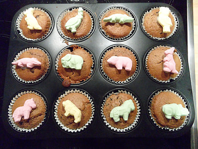 black cake pan with baked chocolate cupcakes top with animal candies thumbnail