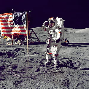 astronaut standing in front of flag of America thumbnail