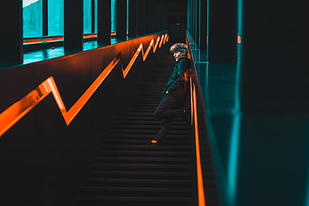 man leaning on wall inside building thumbnail