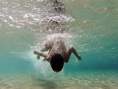 boy swimming during daytime thumbnail