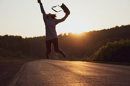 Woman Jumped on Gray Asphalt Road thumbnail