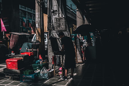 man standing in front of container beside building thumbnail