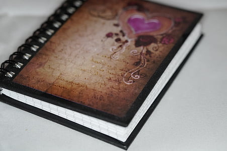 selective focus photography of brown spiral notebook thumbnail