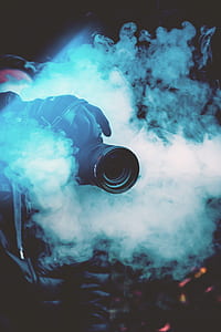 black DSLR camera above smoke thumbnail