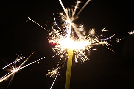 yellow sparkler at nighttime thumbnail