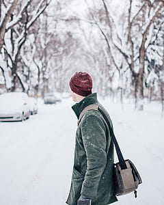 man standing on snow-covered field thumbnail