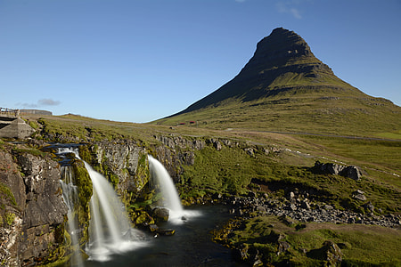 timelapse photography of waterfalls near green hills during daytime thumbnail