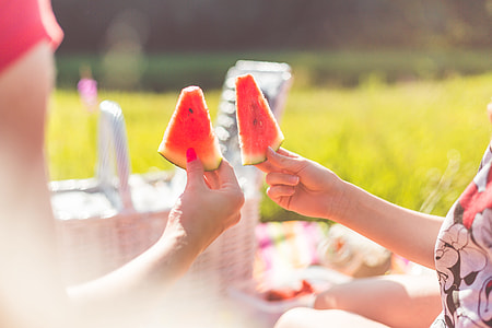 Woman With Child Enjoying Fresh Picnic Melon thumbnail