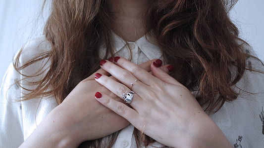 woman wearing two silver-colored ring with clear gemstone and white top thumbnail