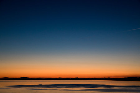 body of water under blue sky with orange background thumbnail