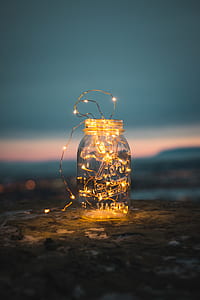 selective focus photography of clear glass jar with string lights inside thumbnail