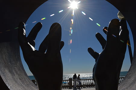 person rising hand during daytime thumbnail