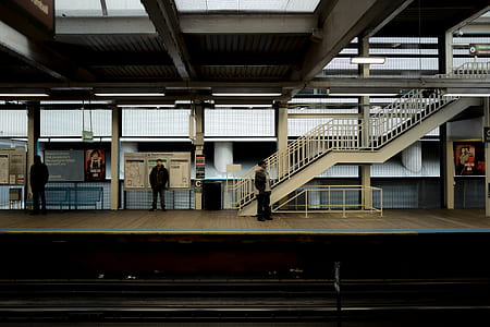 people standing near train rails thumbnail