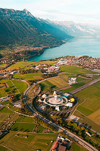 aerial view of stadium surrounded by trees thumbnail