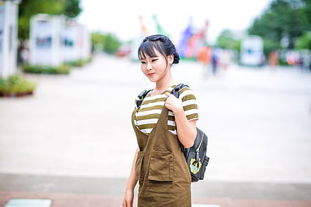 selective focus photography of woman carrying backpack thumbnail