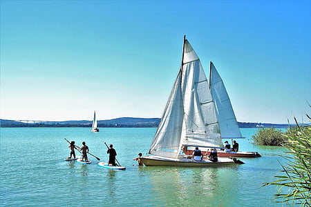 people riding sail boat thumbnail
