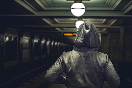 Person Wearing Gray Hooded Jacket in Train Station thumbnail