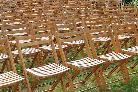 brown wooden folding chairs on green grass thumbnail