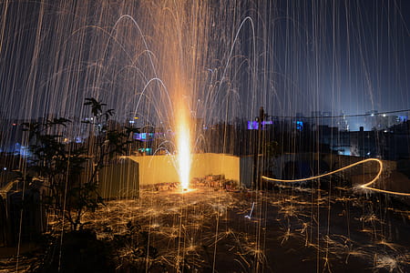 Steel Wool Photography of Plant on Roof Top during Nighttime thumbnail