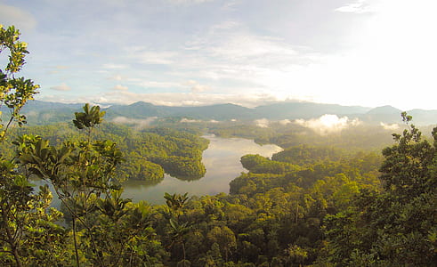 landscape photography of river across mountains under white clouds blue skies thumbnail