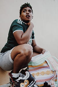 Woman Wearing Green Jersey Holding Multicolored Towel thumbnail