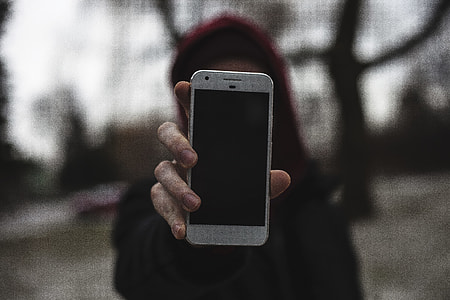woman holding very silver Google Pixel smartphone thumbnail