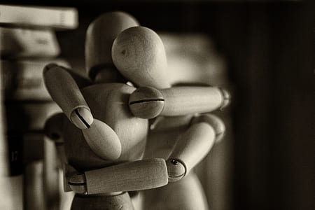 two beige wooden manikin hugging thumbnail