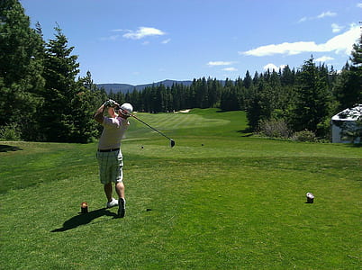 man strikes golf ball with golf club thumbnail