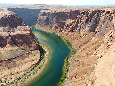 brown canyon between a river during daytime thumbnail