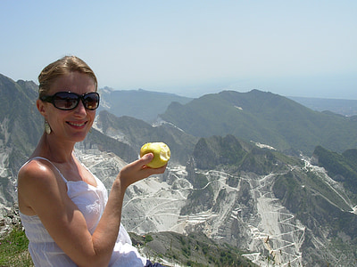 woman holding apple on top of mountain thumbnail