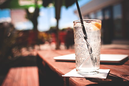 cold beverage topped with sliced apple on wooden table thumbnail