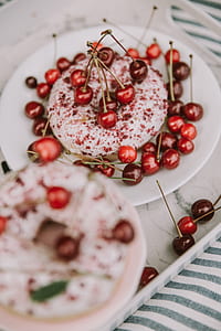 closeup photo of doughnut with cherries on plate thumbnail