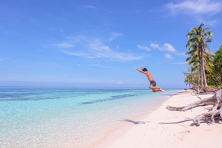 man on sea under blue sky thumbnail