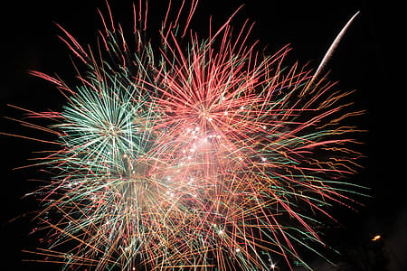 Pink and Green Fireworks Display during Nighttime thumbnail