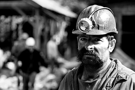 grayscale photography of man wearing hard helmet thumbnail