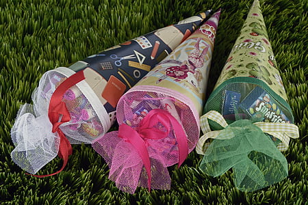 three green, white, and black gift packs on grass field thumbnail