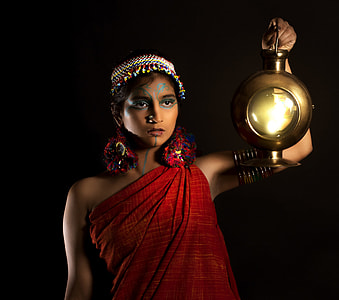 Woman holding brass round lantern thumbnail