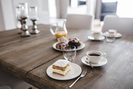 Sweet dessert with cream and a cup of coffee on a table thumbnail