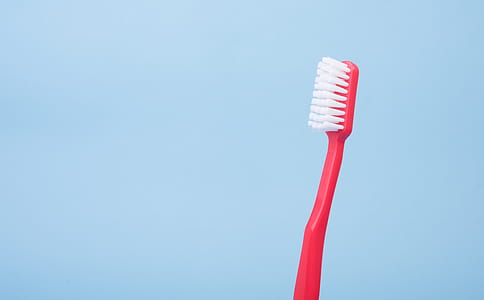 red and white plastic toothbrush thumbnail