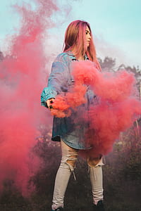 woman wearing oversized blue denim dress shirt holding red smoking device thumbnail