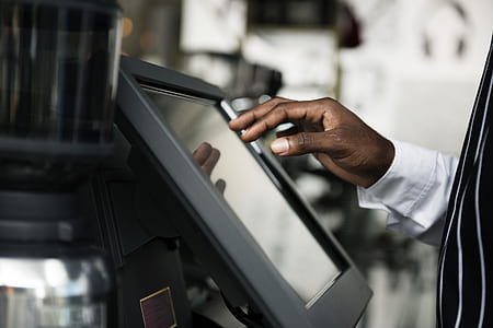 person wearing black and white shirt in front of digital control panel thumbnail