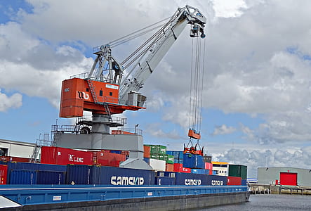 blue and red intermodal container on ship during daytime thumbnail